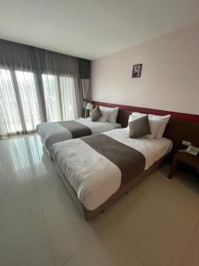 Ένα ή περισσότερα κρεβάτια σε δωμάτιο στο Siam Triangle Hotel