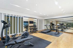 a gym with treadmills and cardio equipment in a room at Swiss-Belinn Modern Cikande in Serang