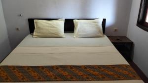 Postel nebo postele na pokoji v ubytování Palm Homestay Kuta