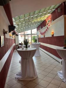 a restaurant with sinks in the middle of a room at Hotel Weinstube am Markt in Gerolzhofen