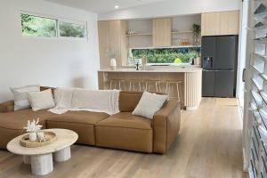a living room with a couch and a kitchen at Casa Tropico - Mission Beach in Mission Beach