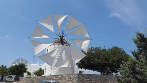 a large white windmill on top of a wall at Margarita Studios in Parikia