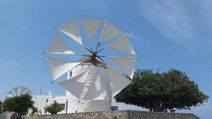 a large white windmill on top of a building at Margarita Studios in Parikia