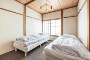 Postel nebo postele na pokoji v ubytování ザホテル湯沢オリエンタル