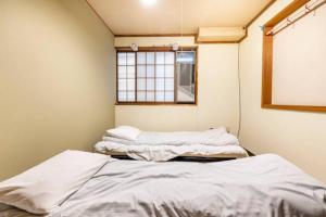 Postel nebo postele na pokoji v ubytování ザホテル湯沢オリエンタル