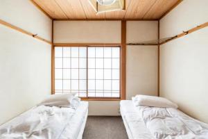 Postel nebo postele na pokoji v ubytování ザホテル湯沢オリエンタル