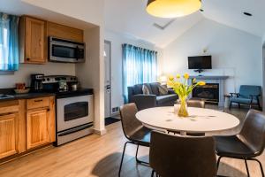 a kitchen and living room with a table and chairs at Inn at Haystack Rock in Cannon Beach