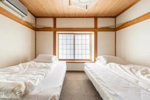 Postel nebo postele na pokoji v ubytování ザホテル湯沢オリエンタル