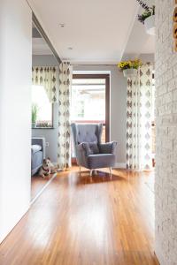 salon z krzesłem i drewnianą podłogą w obiekcie Apartament Nosalowy Sen Jacuzzi & Sauna w Zakopanem