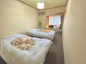 Postel nebo postele na pokoji v ubytování ザホテル湯沢オリエンタル