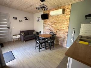 a living room with a table and chairs and a couch at Domek w centrum miasta in Malbork