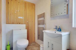 a bathroom with a white toilet and a sink at Hilltop Farm in Sturminster Newton
