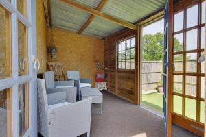 a room with chairs and a door to a patio at Hilltop Farm in Sturminster Newton +17 photos