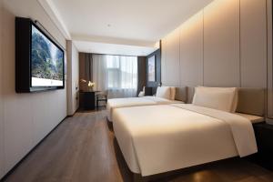 Posteľ alebo postele v izbe v ubytovaní Atour Hotel Xichang Municipal Affairs Center