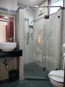 a bathroom with a shower and a sink at Khon Kaen Orchid Hotel in Khon Kaen