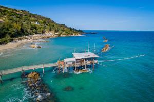 a dock in the water next to a beach at La Casetta di Gabri in San Vito Chietino