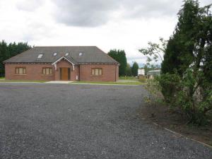 a large brick house with a driveway in front of it at Forest View Holiday Park in Burscough