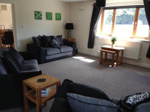 a living room with two couches and a table at Forest View Holiday Park in Burscough