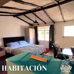 a bedroom with a bed and a table in it at Aparta estudio campestre in Chía