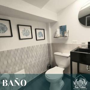 a bathroom with a white toilet and a sink at Aparta estudio campestre in Chía