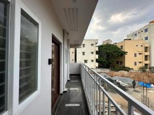 a balcony with a view of a building at Cozy Room 1Bhk with Lift 202 in Bengaluru