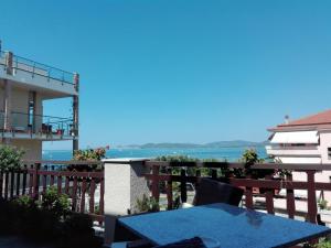 a balcony with a table and a view of the ocean at L'Ambra in Alghero