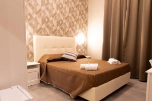Postel nebo postele na pokoji v ubytování Golden Milano Hotel