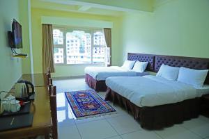 Ένα ή περισσότερα κρεβάτια σε δωμάτιο στο Hotel Bhutan Kubera