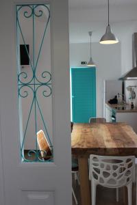 une cuisine avec une table en bois et une porte bleue dans l'établissement Aqua Sea House, à Madalena do Mar
