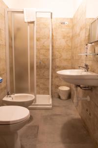a bathroom with a toilet and a sink and a shower at Golden Milano Hotel in Milan