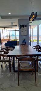 a dining room with a large wooden table and chairs at Pool Villa Romance in Sawi