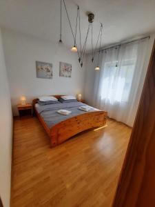 a bedroom with a large wooden bed in a room at Apartman Mila in Novi Vinodolski