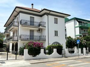 a white building with balconies on a street at Perla marina in Vasto