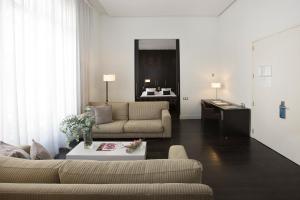 uma sala de estar com um sofá e uma mesa em Hospes Palau de La Mar, Valencia, a Member of Design Hotels em Valência