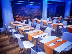 a row of tables and chairs in a room at MB Boutique Hotel - Adults Recommended in Nerja