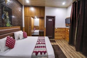 a bedroom with a large bed in a room at Airport Hotel Peebles in New Delhi