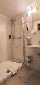 a bathroom with a shower and a sink at Hotel Zum Bürgergarten in Stolberg i. Harz