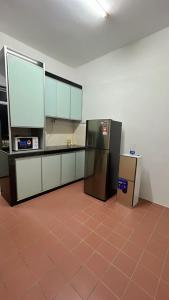 a kitchen with two refrigerators in a room at Homestay Ghumah Che,gu in Melaka +6 photos