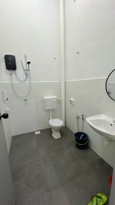 a bathroom with a toilet and a sink at Homestay Ghumah Che,gu in Melaka