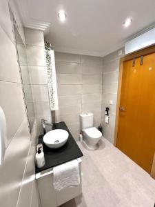 a bathroom with a sink and a toilet at Apartamento junto campo de GOLF LA SELLA in Muntanya la Sella +15 photos