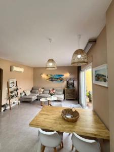 a living room with a wooden table and chairs at Apartamento junto campo de GOLF LA SELLA in Muntanya la Sella