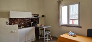 a kitchen with a counter and a table in a room at San Vito Accommodations in San Vito lo Capo