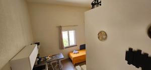 a room with a bedroom with a bed and a window at San Vito Accommodations in San Vito lo Capo