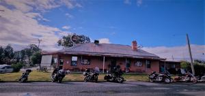 a group of motorcycles parked in front of a building at Lockhart Railway Hotel in Lockhart