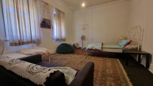 a living room with a couch and a table at Lockhart Railway Hotel in Lockhart
