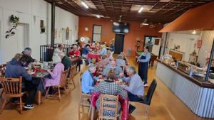 a group of people sitting at tables in a restaurant at Lockhart Railway Hotel in Lockhart