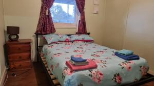 a bedroom with a bed with towels on it at Lockhart Railway Hotel in Lockhart