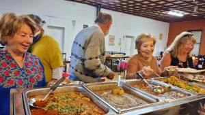 a group of people standing around a buffet of food at Lockhart Railway Hotel in Lockhart