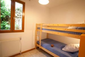a bedroom with two bunk beds and a window at Gites La Palombière La Gardelle in Bézenac