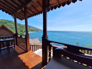 a view of the ocean from the porch of a resort at Amed Santorini Villa in Amed